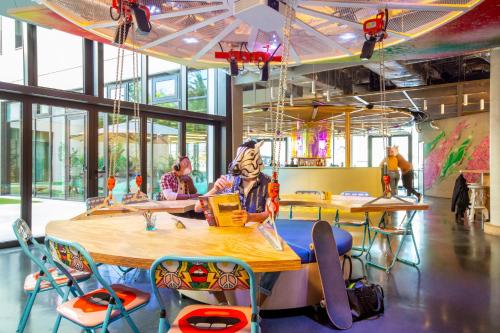 a classroom with tables and chairs with skateboards on them at JO&JOE Paris Gentilly - Auberge de Jeunesse in Gentilly