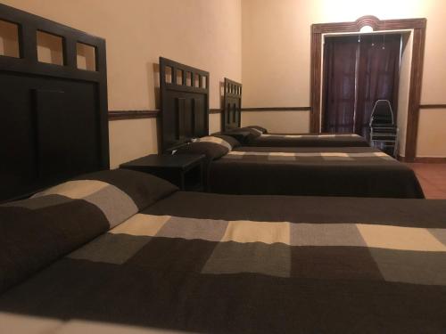 Een bed of bedden in een kamer bij La Ilusión Hotel Campestre y Balneario