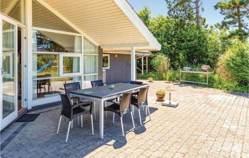 a patio with a table and chairs on a patio at Amazing Home In Slagelse With Kitchen in Slagelse