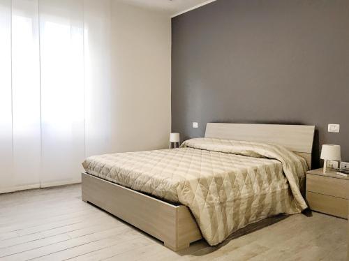 a bedroom with a bed and a large window at Bilocale Sirio-Intero appartamento ad uso esclusivo by Appartamenti Petrucci by Appartamenti Petrucci in Foligno