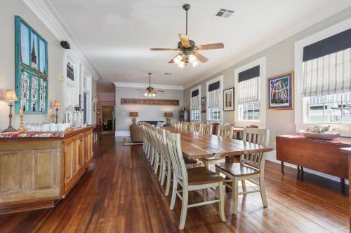 a dining room with a wooden table and chairs at Elysian Fields Inn in New Orleans