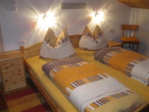 a bedroom with two beds with pillows on them at Rossruckhof in Rohrberg