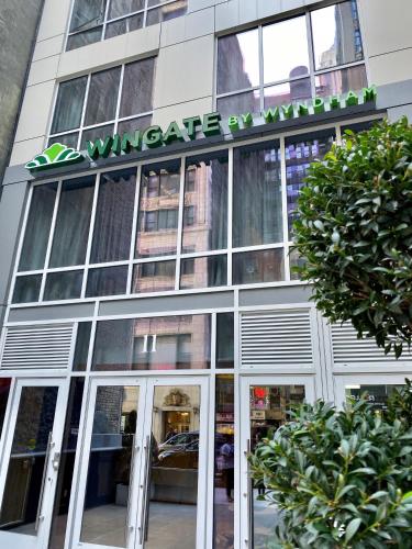 a store front of a building with a sign on it at Wingate by Wyndham New York Midtown South/5th Ave in New York