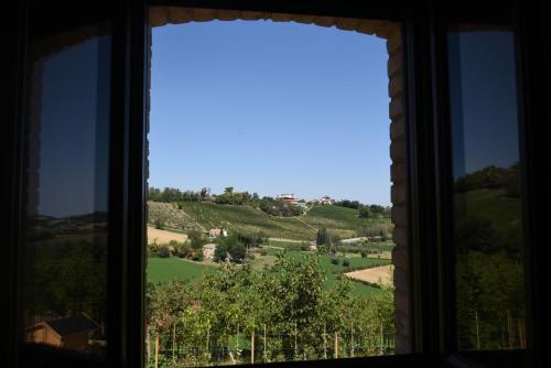 a window with a view of a green field at Villa Shmitanka in Servigliano