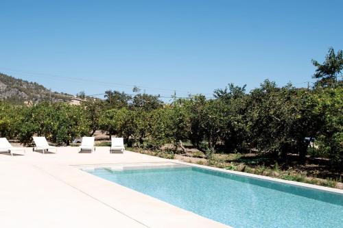 a swimming pool with two lounge chairs and a pool at Villa Can Batach-Nueva Construcción en Sóller in Sóller