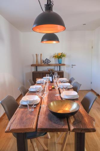 a large wooden table with glasses and a bowl on it at Feriendomizil "Alte Post" II in Pronsfeld