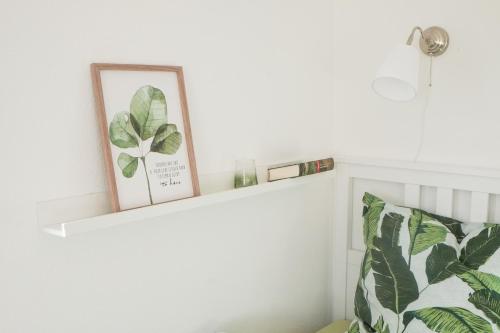 a shelf with a picture and a plant on it at Feriendomizil "Alte Post" II in Pronsfeld