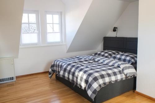 a bedroom with two beds and two windows at Feriendomizil "Alte Post" II in Pronsfeld