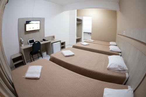 Säng eller sängar i ett rum på Getúllio Hotel