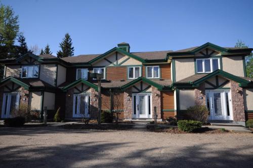a large house with a large driveway in front of it at Aiglon by Rendez-Vous Mont-Tremblant in Mont-Tremblant
