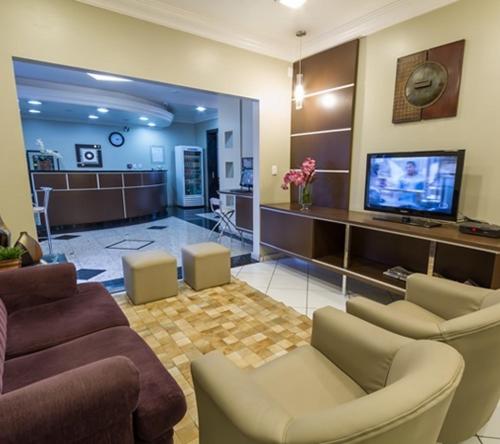 a living room with couches and a flat screen tv at Bellmont Hotel in Concordia