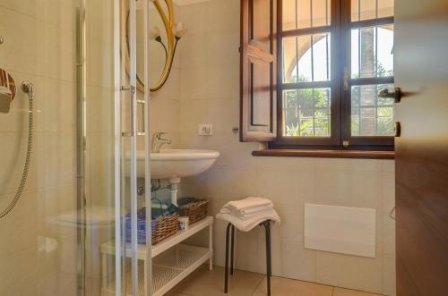 a bathroom with a sink and a glass shower at B&B La Torretta in Loano