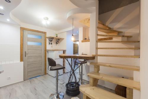 uma escada numa casa minúscula com um banco em TatraApart Rent E-Bike em Kościelisko