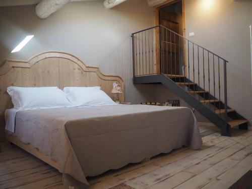 a bedroom with a large bed and a staircase at B&B Antique Maison in Soave