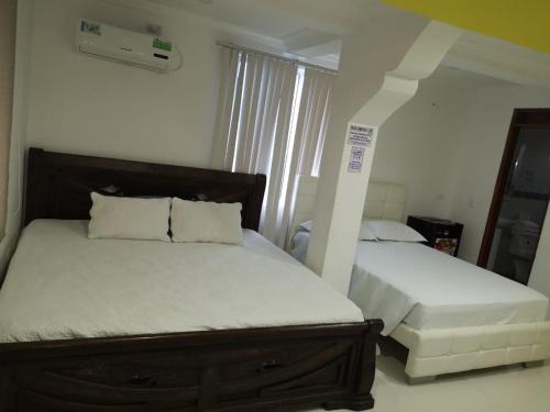 Ένα ή περισσότερα κρεβάτια σε δωμάτιο στο Apartamentos Isla Tropical