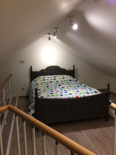 a bedroom with a bed in a attic at GITE D'Hotlîs in Aywaille