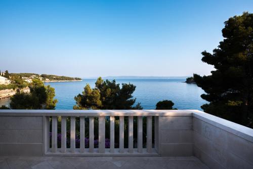 a balcony with a view of the water at Villa Katja in Sumartin