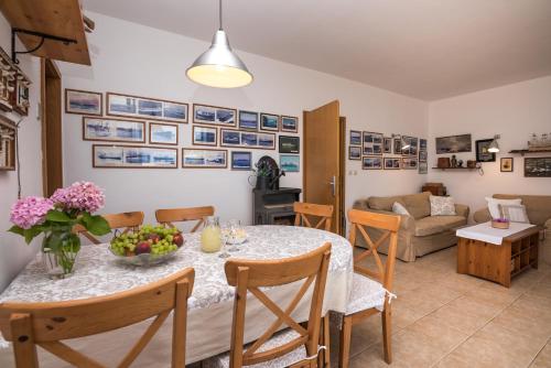 a dining room and living room with a table and chairs at Villa Katja in Sumartin