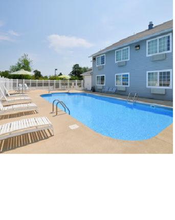 a large swimming pool in front of a building at Days Inn by Wyndham Mountain Home in Mountain Home