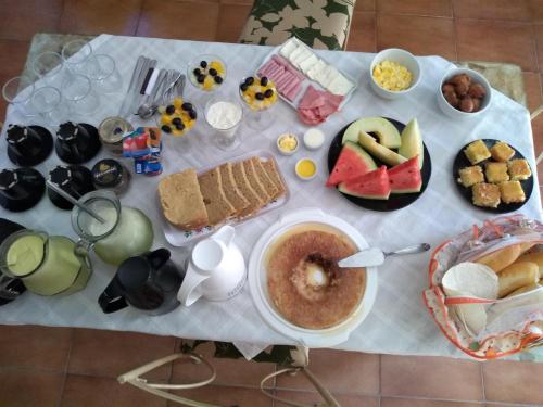 a table with food and a cup of coffee on it at Casa da Coruja in Rio de Janeiro