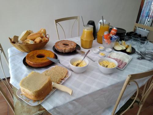 a table with bread and other foods on it at Casa da Coruja in Rio de Janeiro