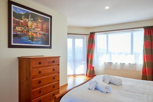 a bedroom with a bed with two pillows on it at Coastal Spacious Mountain Views in Kaikoura