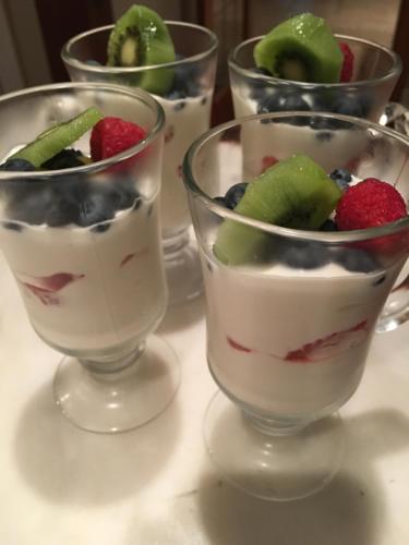 four glasses of dessert with fruit in them on a table at Amante Luxury Bed & Breakfast in Victoria