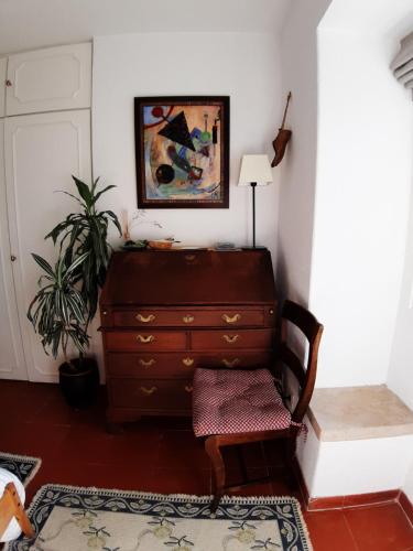 a living room with a dresser and a plant at Isa's Home in Sintra