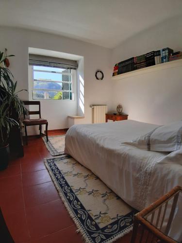 a bedroom with a large bed and a window at Isa's Home in Sintra
