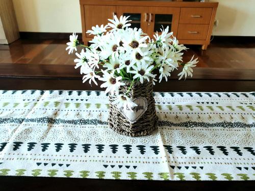 a vase of white flowers sitting on a table at Bedugul Lake View Residence Unit B-6 in Bedugul