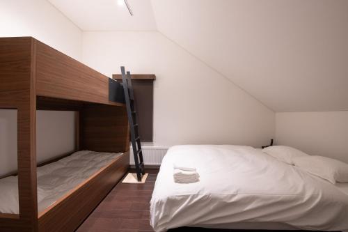a bedroom with a bed and a bunk bed at La Plagne in Kutchan