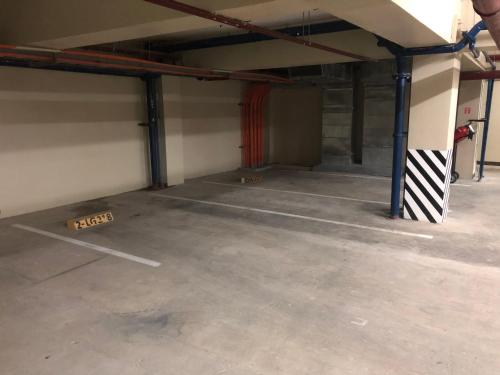 an empty garage with a parking lot in it at Your Own 3 C's Space (Cozy, Clean and Convenient)! in Tagaytay