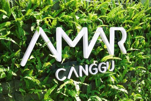 a sign that says amazon camazon in a bush at Amar Boutique Hotel in Canggu