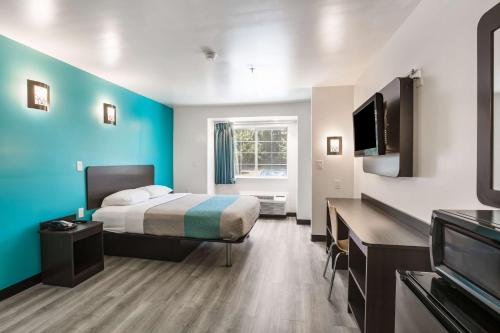 a hotel room with a bed and a flat screen tv at Motel 6-Smyrna, GA - Atlanta in Atlanta