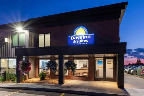 a day inn and suites sign on the front of a building at Days Inn & Suites by Wyndham Duluth by the Mall in Duluth