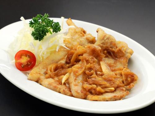 a white plate of food with meat and onions at Business Hotel Nishikiryu in Kiryu