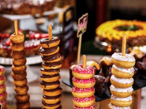 a display of cookies and donuts on a table at ibis Styles London Southwark - near Borough Market in London