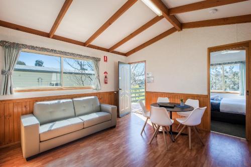 a living room with a couch and a table at Discovery Parks - Lake Hume, New South Wales in Lake Hume