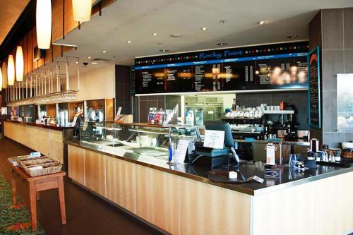 a bar in a restaurant with a counter at BASE Holidays - Ettalong Beach Premium Apartments in Ettalong Beach