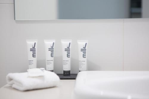 a row of fourental products on a counter in a bathroom at Quest Nowra in Nowra