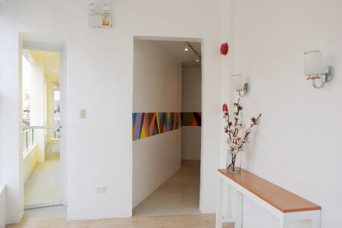 a hallway with white walls and a wooden table at Kamusta Boutique Hotel in Boracay