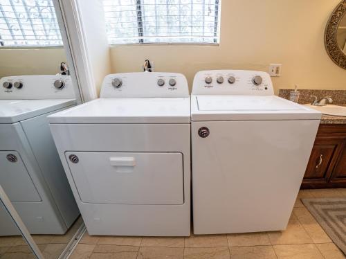 a laundry room with two washer and dryer at Your Home in LA in Los Angeles