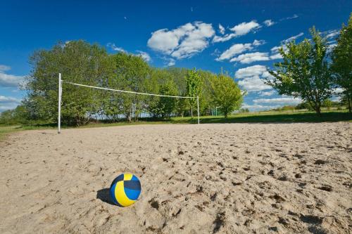 a volleyball ball on a sandy field with a goal at KNAUS Campingpark Hünfeld in Hünfeld