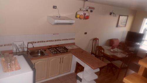 a kitchen with a sink and a stove top oven at Apart Hotel en Puerto Montt in Puerto Montt