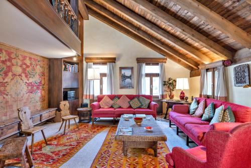 a living room with red couches and a table at Chesa Cromer - Celerina in Celerina