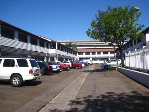a parking lot with cars parked in front of a building at EZ 8 Motel Old Town in San Diego