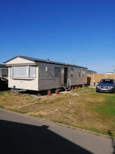 a mobile home is parked in a yard at Caravan ( Static, within a super holiday park ) in Birchington
