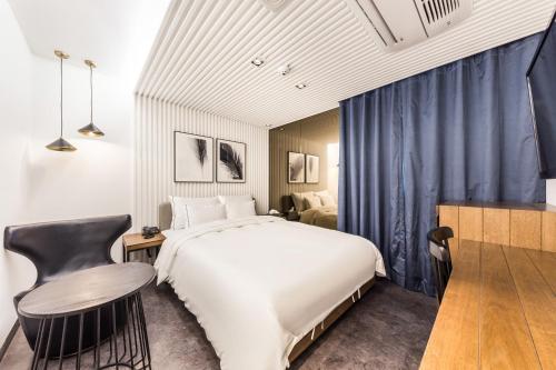 ソウルにあるForestar Hotel Sinchonのベッドルーム1室(大型ベッド1台、テーブル、椅子付)