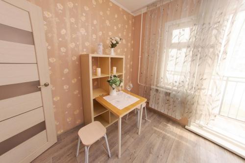 a small room with a table and a window at Заречная 1-ая, 6 in Kemerovo