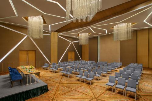 a banquet hall with chairs and tables in a room at Novotel Ahmedabad in Ahmedabad